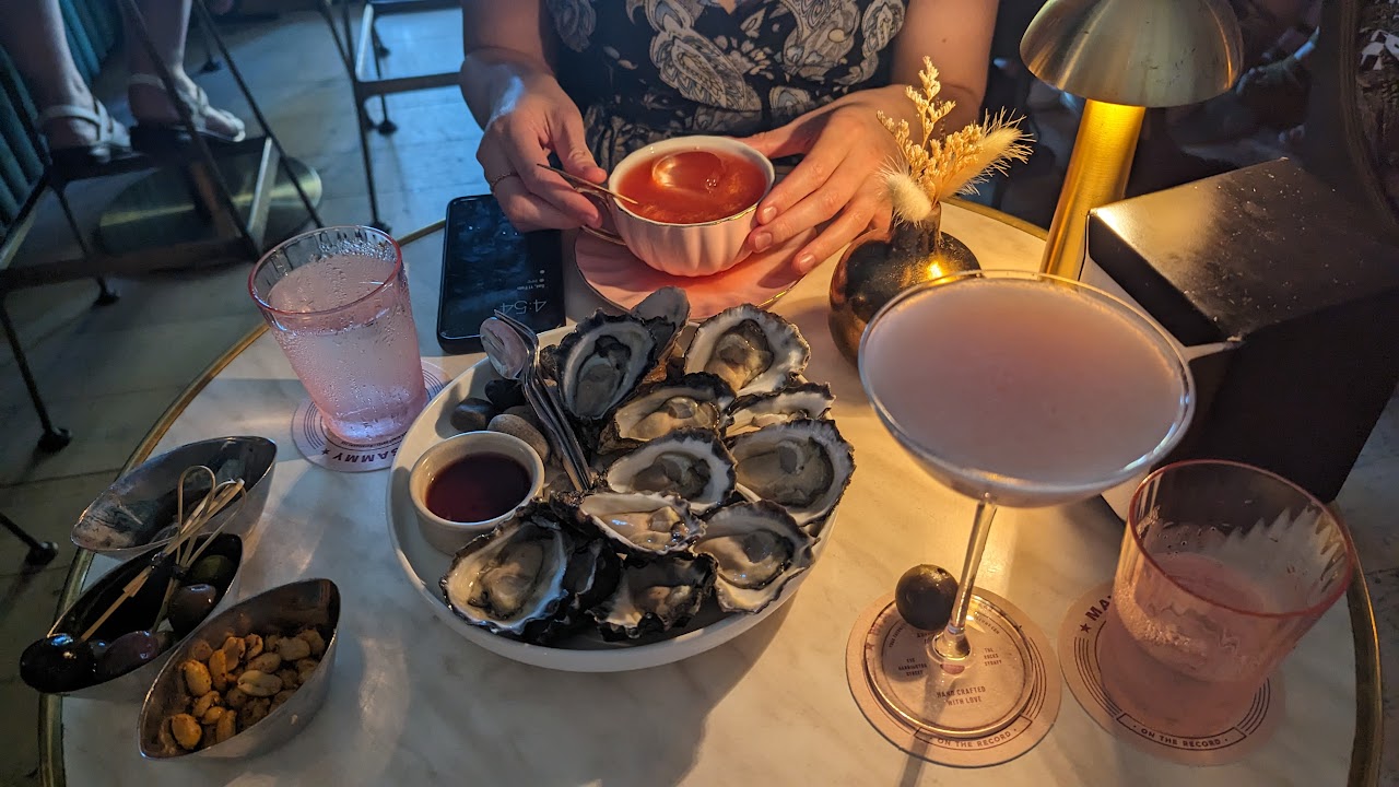 Cocktails and snacks arranged on a Maybe Sammy table