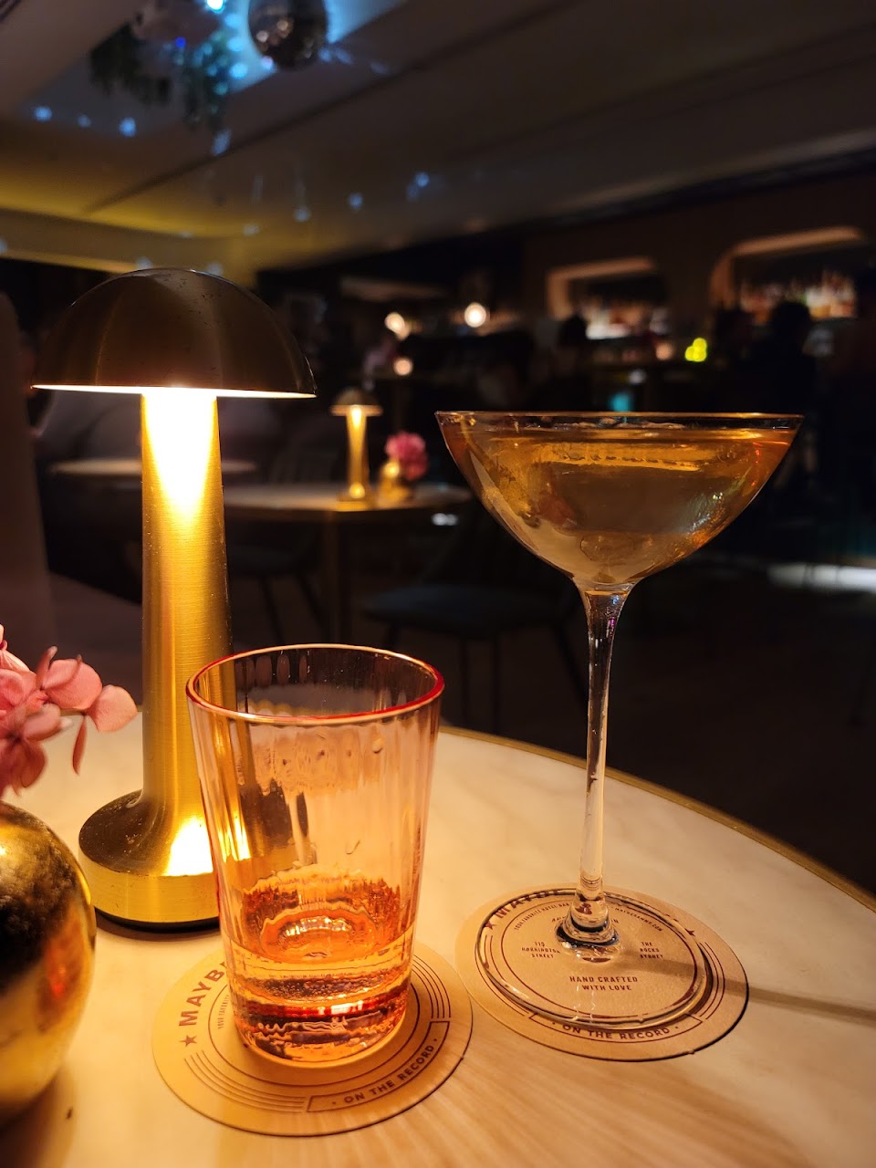 Two cocktails on a low-lit table at Maybe Sammy